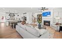 Open concept living space with fireplace, hardwood floors and a view into the kitchen at 5760 Tillman Way, Powder Springs, GA 30127