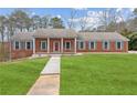Classic brick home with blue shutters, manicured lawn, and inviting walkway at 3113 Melissa Ct, Douglasville, GA 30135