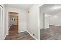 Neutral hallway featuring modern gray walls and dark wood flooring at 3113 Melissa Ct, Douglasville, GA 30135