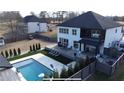 Aerial view of a backyard oasis, pool, patio, and outdoor lounge for entertaining and relaxation at 557 Loth Wages Rd, Dacula, GA 30019