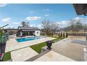 Lush backyard with private swimming pool, outdoor kitchen, and lounge areas for relaxing and entertaining at 557 Loth Wages Rd, Dacula, GA 30019