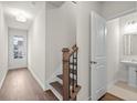 Bright entryway features wood floors, staircase, and a glimpse of the half bath, offering convenience at 706 Smokey Quartz Way, Kennesaw, GA 30144
