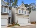 Charming two-story home featuring neutral siding, a white garage door, and tidy landscaping at 706 Smokey Quartz Way, Kennesaw, GA 30144