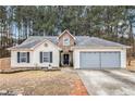Charming single-Gathering home featuring a two-car garage and inviting front yard at 11765 Fairway Overlook, Fayetteville, GA 30215