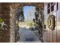Stone archway provides a glimpse of the manicured yard at 3000 Cathedral Pl, Decatur, GA 30034
