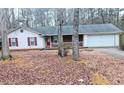 Cozy one-story home with white siding, brick facade, and attached garage at 11006 Clearwater Dr, Hampton, GA 30228