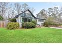 Exterior view of a home with a well-kept lawn and unique window design and black trim at 2720 Creekview Nw Pt, Marietta, GA 30064