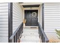 Charming front entry featuring a black door and steps leading to the main entrance at 2720 Creekview Nw Pt, Marietta, GA 30064