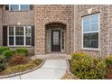 Close up of the front entrance to the brick home with brick archway and professional landscaping at 380 Parkside Meadow Sw Dr, Marietta, GA 30064