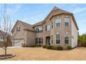 Charming two-story brick home with an attached garage and manicured lawn and bushes at 380 Parkside Meadow Sw Dr, Marietta, GA 30064