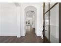 Inviting foyer with hardwood floors, archway, and glass paneled door at 3909 Enclave Way, Tucker, GA 30084