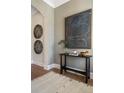 Inviting hallway with decorative wall art, an accent table, and a patterned rug at 3909 Enclave Way, Tucker, GA 30084