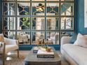 Stunning living room featuring a unique mirror wall design, accent furniture, and neutral tones at 3909 Enclave Way, Tucker, GA 30084