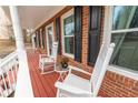 Inviting front porch with two rocking chairs and a small table, perfect for relaxing at 4283 Northwind Dr, Ellenwood, GA 30294