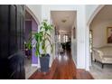 Spacious hallway with hardwood floors, neutral walls, and an open doorway at 4283 Northwind Dr, Ellenwood, GA 30294