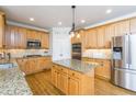 Well-equipped kitchen with wood cabinets, granite countertops, and stainless steel appliances at 445 Edenbrooke Way, Roswell, GA 30075