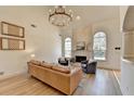 Bright living room with vaulted ceilings, fireplace, modern lighting, and hardwood floors at 212 Sunset Hills Dr, Norcross, GA 30071