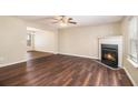 Inviting living room featuring a cozy fireplace, wood flooring, and ample natural light, perfect for relaxation at 256 Coral Cir, Mcdonough, GA 30253