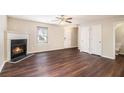 Spacious living room boasts a fireplace, wood floors, a ceiling fan, and abundant natural light at 256 Coral Cir, Mcdonough, GA 30253