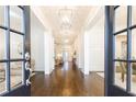 Elegant foyer featuring dark wood floors, detailed trim, and modern pendant lighting at 765 Glengate Pl, Atlanta, GA 30328