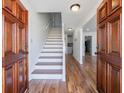 Bright foyer with hardwood floors, staircase, and view into dining area at 857 Winding Trl, Lawrenceville, GA 30046