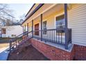 Inviting front porch with brick foundation and decorative railing at 857 Winding Trl, Lawrenceville, GA 30046