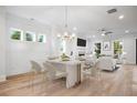 Open concept dining area with a modern chandelier and seamlessly connected to the living room at 1010 Coleman Place Dr, Roswell, GA 30075