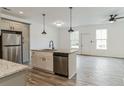 Modern kitchen with stainless steel appliances, an island with a sink, and wood-look flooring at 4011 Redan Rd. # 6, Stone Mountain, GA 30083