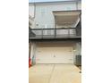 Rear view featuring a large, two car garage and balcony at 161 Jameson Dr, Acworth, GA 30102