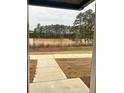 Scenic view from the front door of a calm pond, surrounded by lush trees at 161 Jameson Dr, Acworth, GA 30102