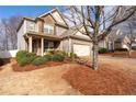 Beautiful two-story home with stone accents, mature landscaping, and a welcoming front porch at 5211 Centennial Hill Nw Dr, Acworth, GA 30102