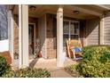 Inviting front porch featuring stacked stone accents and a classic rocking chair, perfect for relaxing outdoors at 5211 Centennial Hill Nw Dr, Acworth, GA 30102