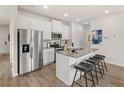 Modern kitchen with white cabinets, stainless steel appliances, granite countertops, and breakfast bar seating at 216 Epping St # 5, Stockbridge, GA 30281