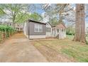 Charming home featuring a quaint covered porch, gray siding and freshly painted white brick at 2769 Glenwood Se Ave, Atlanta, GA 30317