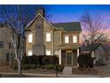 Charming two-story home with stone accents, mature landscaping and covered front entry at dusk at 3769 Baxley Point Dr, Suwanee, GA 30024