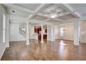 Open-concept living and dining areas with hardwood floors, coffered ceilings, and abundant natural light at 3769 Baxley Point Dr, Suwanee, GA 30024