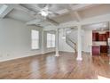 Open-concept living and dining areas with hardwood floors, coffered ceilings, and abundant natural light at 3769 Baxley Point Dr, Suwanee, GA 30024