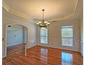 Dining room features hardwood floors, crown molding, and large windows at 5780 Warren Farm Sw Rd, Powder Springs, GA 30127
