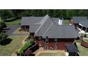 Side view of a brick house highlighting the spacious backyard and large windows at 5780 Warren Farm Sw Rd, Powder Springs, GA 30127