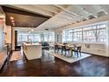 Spacious living room with exposed beams, hardwood floors, modern decor, and large windows providing lots of light at 805 Peachtree Ne St # 317, Atlanta, GA 30308