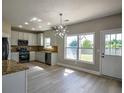 Modern kitchen with stainless steel appliances, stylish backsplash, and granite countertops at 907 Southfork Dr, Loganville, GA 30052