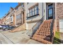 Exterior view of brick townhomes with garages and front entry stairs at 1912 Townsend Ne Ct, Atlanta, GA 30329