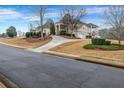 Elegant home with manicured lawn and circular drive leading to a two-car garage at 1069 Eagles Brooke Dr, Locust Grove, GA 30248