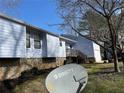 Charming home with light blue siding, stone foundation, and inviting front entrance with stairs and small deck at 1454 Walnut Log Pl, Austell, GA 30168