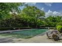 Community pool and sun deck with lounge chairs and tables surrounded by lush landscaping at 1501 Clairmont Rd # 1318, Decatur, GA 30033