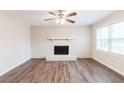 Living room features hardwood floors, a white brick fireplace, and lots of light at 5130 Cornwallis Ct, Stone Mountain, GA 30088