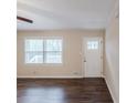Neutral living room features hardwood floors and a white front door at 5130 Cornwallis Ct, Stone Mountain, GA 30088