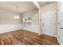 Bright dining area featuring hardwood floors and a modern light fixture at 6040 Oakley Rd, Union City, GA 30291