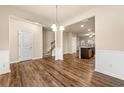 Spacious living room featuring hardwood floors, staircase, and lots of natural light at 6040 Oakley Rd, Union City, GA 30291