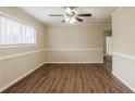 Inviting living room with wood-look flooring, a ceiling fan, and ample natural light at 8673 Chestnut Ln, Lithia Springs, GA 30122